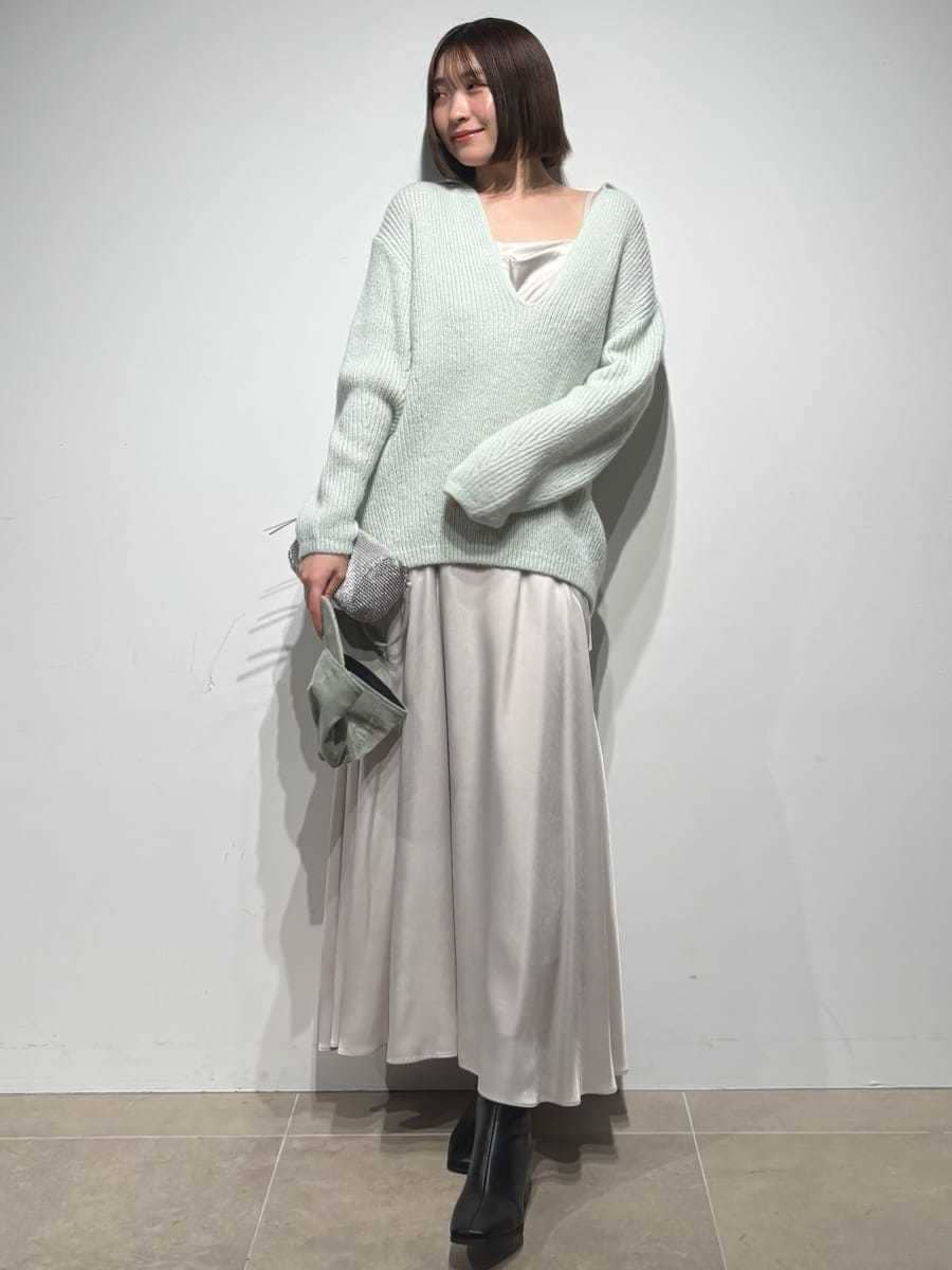 グレー系のブーツ、グリーン系のワンピース、グリーン系のキャップを着用したレディースの冬コーディネートの3枚目の写真