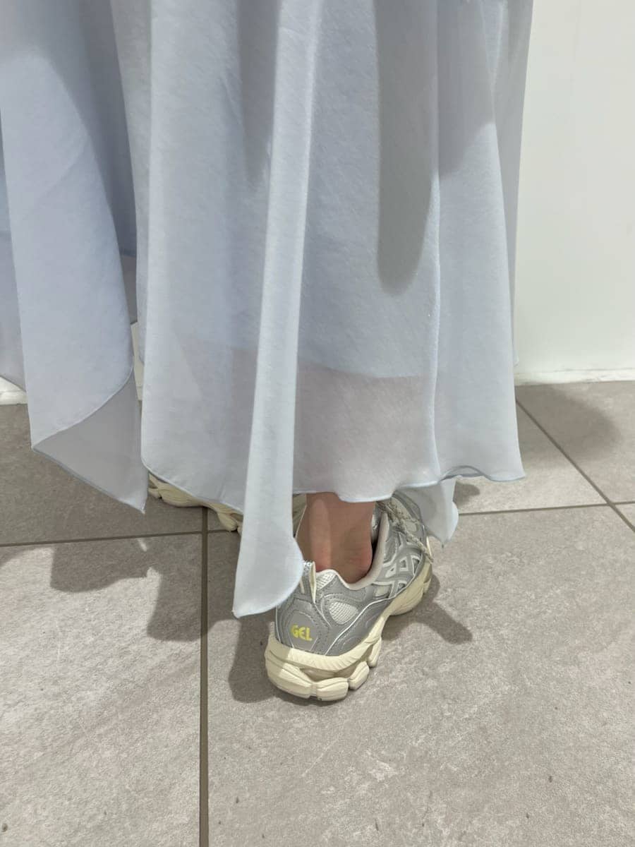 ブルー系のワンピース、ホワイト系のショルダーバッグ、シルバー系のスニーカーを着用したレディースの冬コーディネートの8枚目の写真