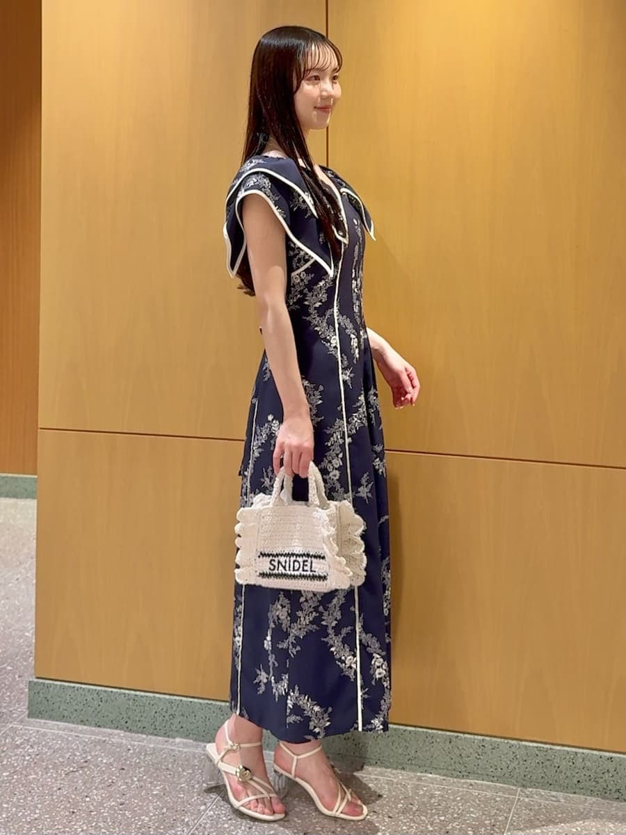 ブルー系のワンピース、ホワイト系のサンダル、ホワイト系のショルダーバッグを着用したレディースの春コーディネートの2枚目の写真