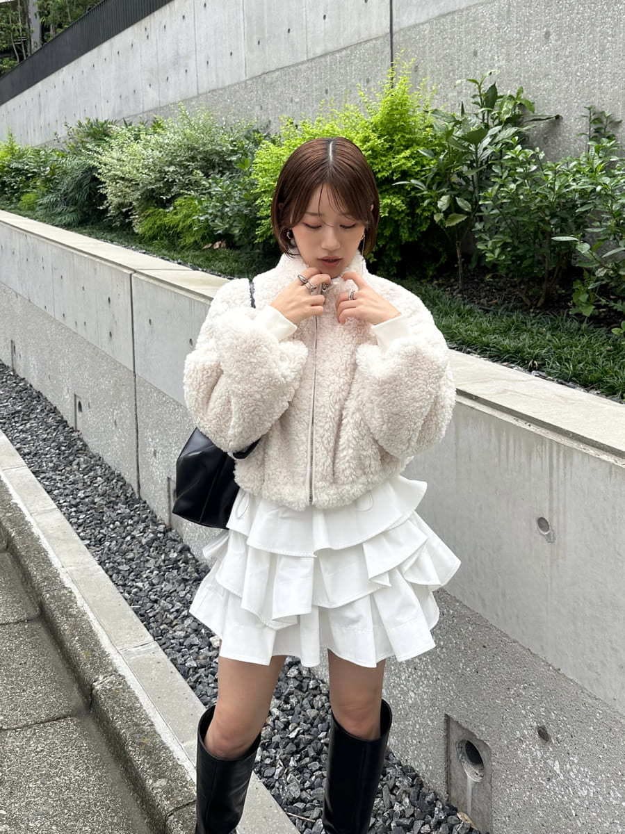 ホワイト系のその他パンツ、ブラック系のブーツ、ブラック系のショルダーバッグを着用したレディースの秋コーディネートの3枚目の写真
