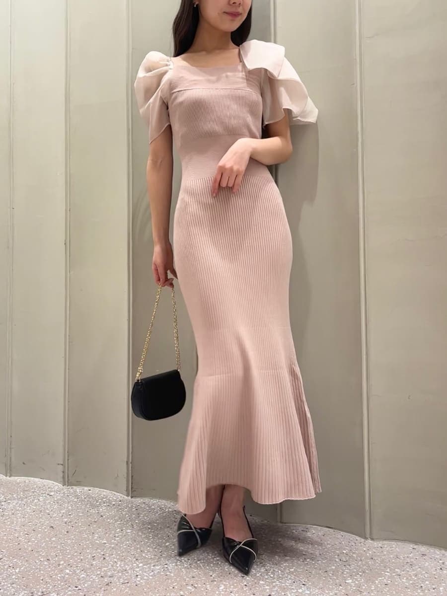 ピンク系のワンピース、ブラック系のパンプス、ブラック系のショルダーバッグを着用したレディースの春コーディネートの3枚目の写真