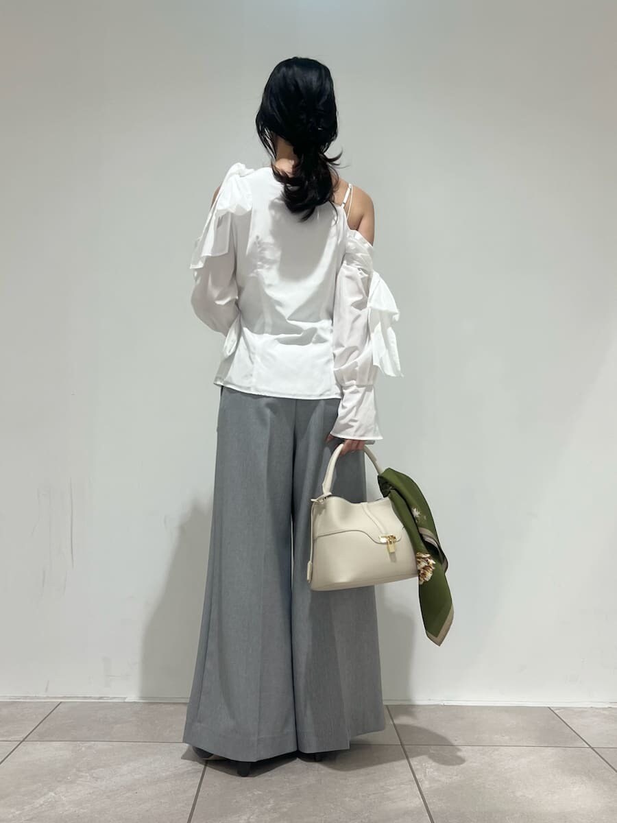 グレー系のブーツ、ホワイト系のハンドバッグ、グレー系のその他パンツを着用したレディースの冬コーディネートの3枚目の写真