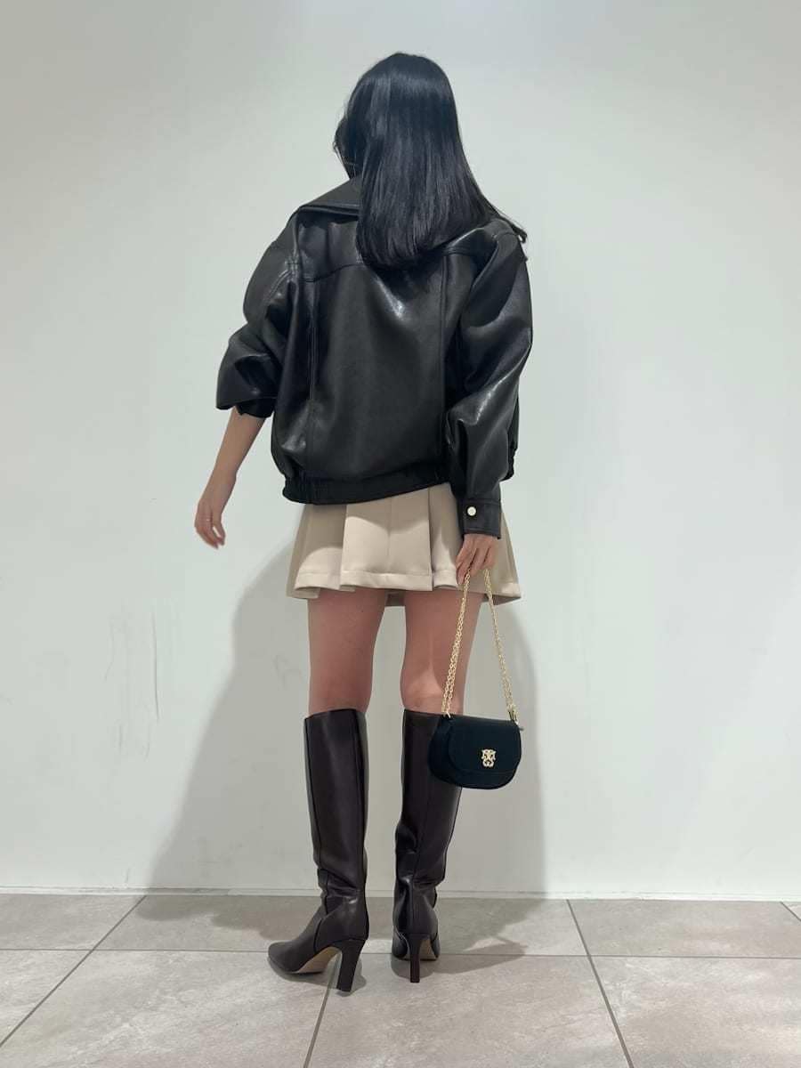 ブラウン系のブーツ、ブラウン系のブルゾン、ベージュ系のスカートを着用したレディースの冬コーディネートの3枚目の写真