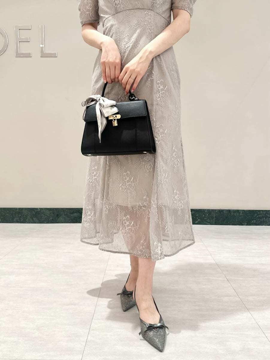 ブラック系のハンドバッグ、ホワイト系のバンダナ/スカーフを着用したレディースの夏コーディネートの3枚目の写真