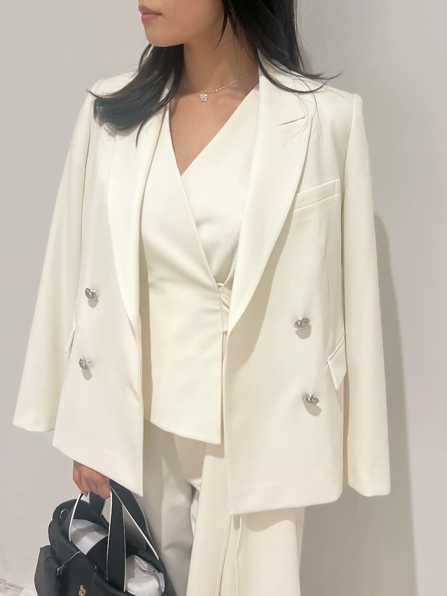 ホワイト系のテーラードジャケット、ホワイト系のスラックス、その他のパンプスを着用したレディースの冬コーディネートの4枚目の写真