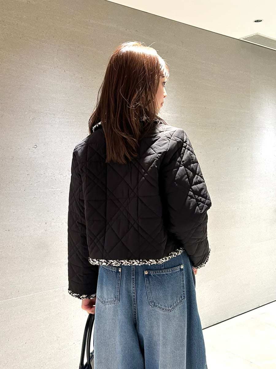 ブルー系のデニムパンツ、ブラック系のテーラードジャケット、ブラック系のニット/セーターを着用したレディースの秋コーディネートの2枚目の写真