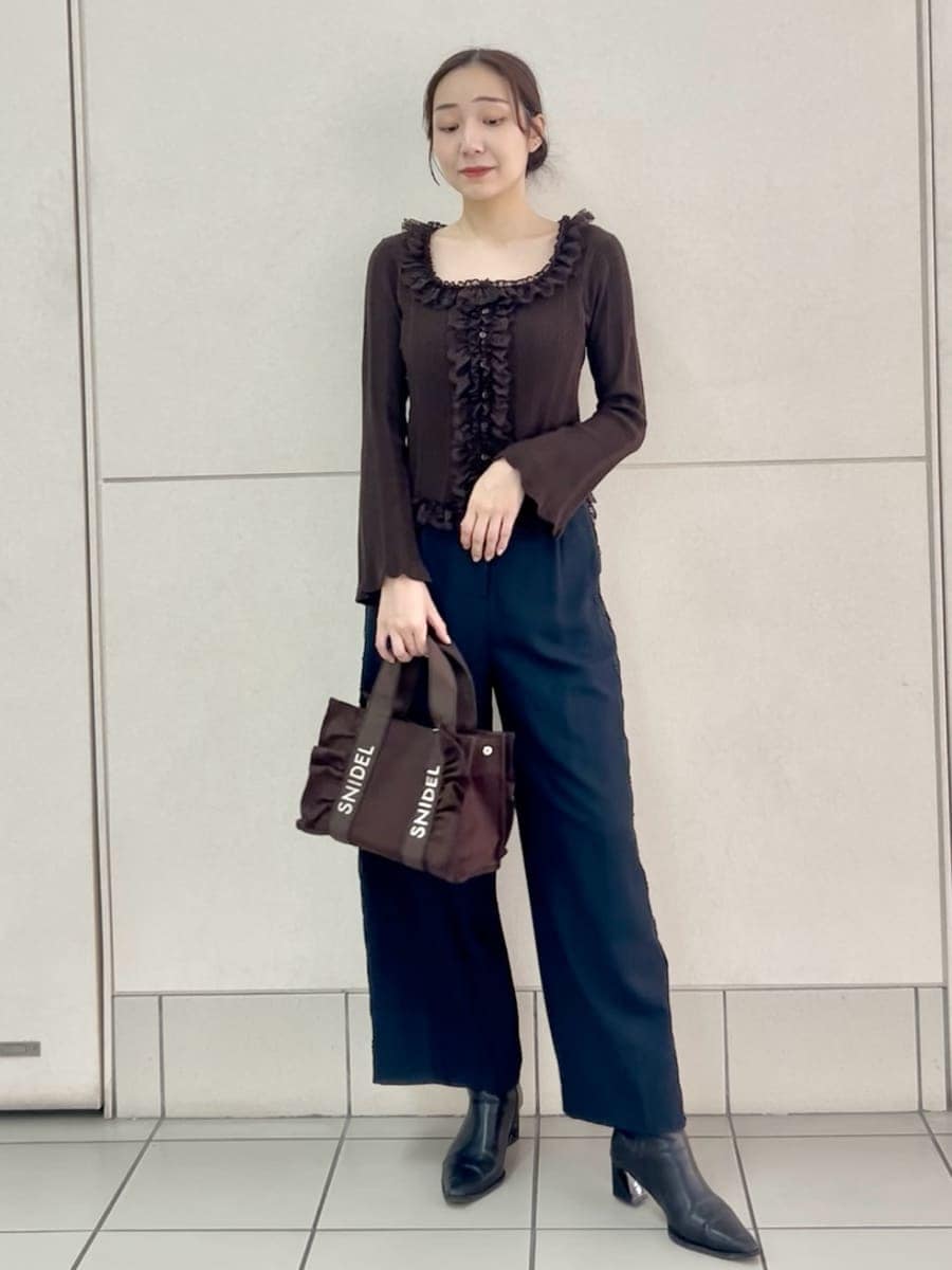 ブラウン系のハンドバッグ、ブルー系のその他パンツ、ブラウン系のニット/セーターを着用したレディースの夏コーディネートの2枚目の写真