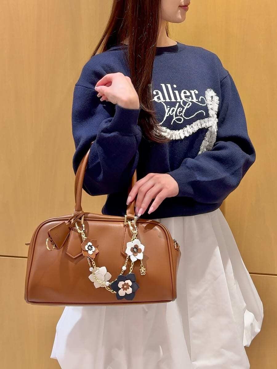 ホワイト系のその他パンツ、ブルー系のニット/セーター、イエロー系のボストンバッグを着用したレディースの冬コーディネートの6枚目の写真