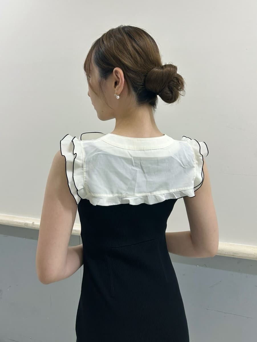 ホワイト系のハンドバッグ、ブラック系のワンピース、ブラック系のサンダルを着用したレディースの夏コーディネートの4枚目の写真