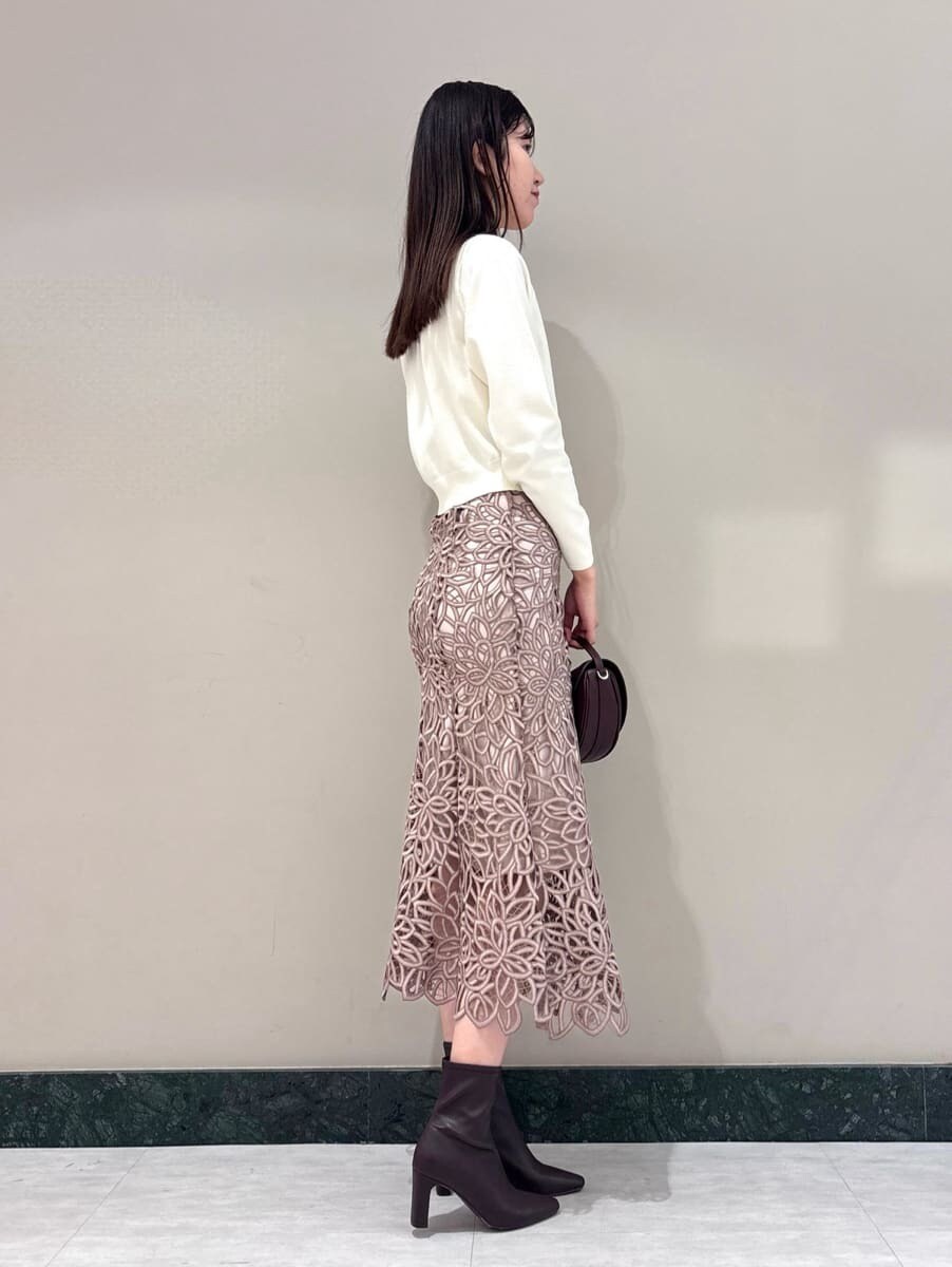 ホワイト系のカーディガン/ボレロ、ピンク系のスカート、ブラウン系のハンドバッグを着用したレディースの夏コーディネートの3枚目の写真