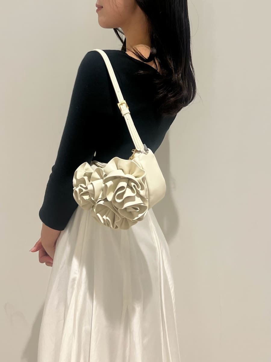 ブラック系のパンプス、ホワイト系のハンドバッグ、その他のワンピースを着用したレディースの冬コーディネートの5枚目の写真