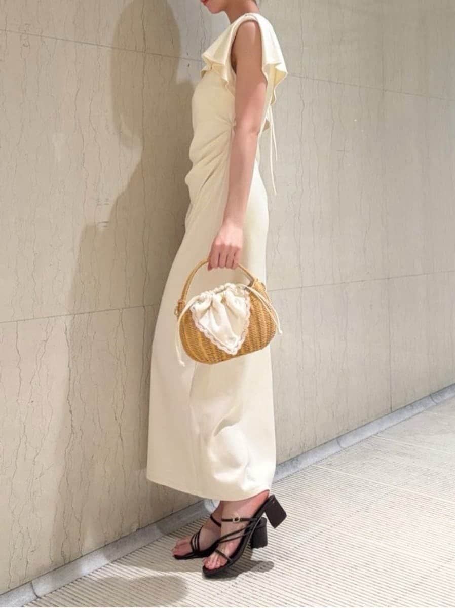 ホワイト系のかごバッグ、ホワイト系のワンピース、ブラウン系のサンダルを着用したレディースの夏コーディネートの2枚目の写真
