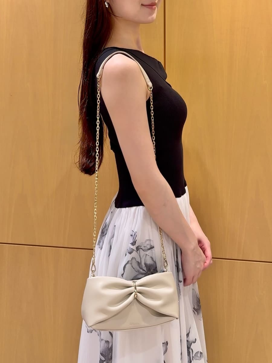 ブラック系のパンプス、ブラック系のワンピースを着用したレディースの夏コーディネートの6枚目の写真