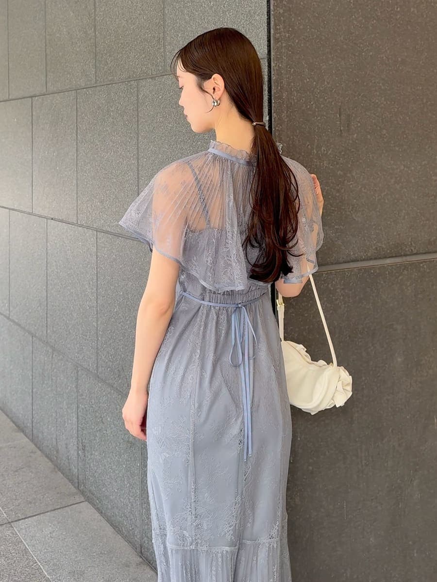 グレー系のドレス、ブラック系のパンプス、ホワイト系のハンドバッグを着用したレディースの春コーディネートの6枚目の写真