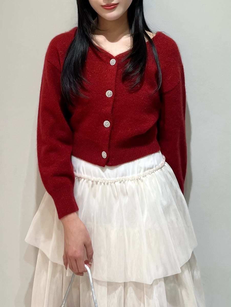 ブラック系のブーツ、ホワイト系のスカート、レッド系のカーディガン/ボレロを着用したレディースの冬コーディネートの4枚目の写真