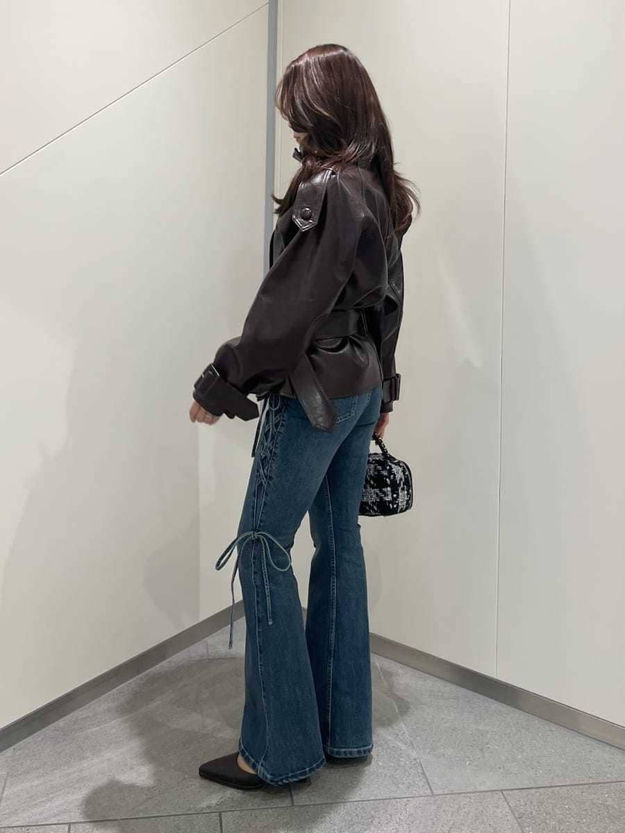 ブラウン系のブルゾン、ブルー系のデニムパンツ、ブラウン系のパンプスを着用したレディースの秋コーディネートの2枚目の写真