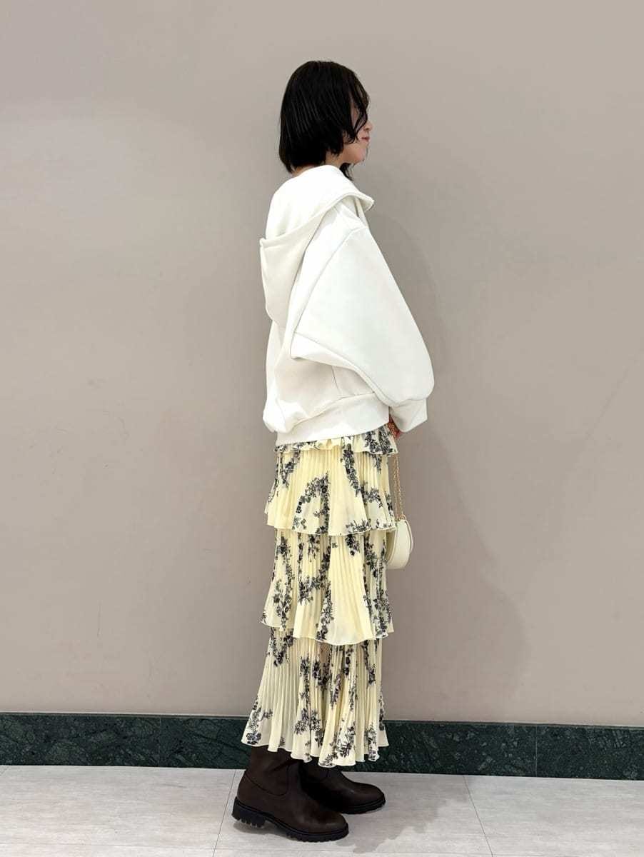 ホワイト系のパーカー、イエロー系のスカート、ホワイト系のショルダーバッグを着用したレディースの冬コーディネートの4枚目の写真