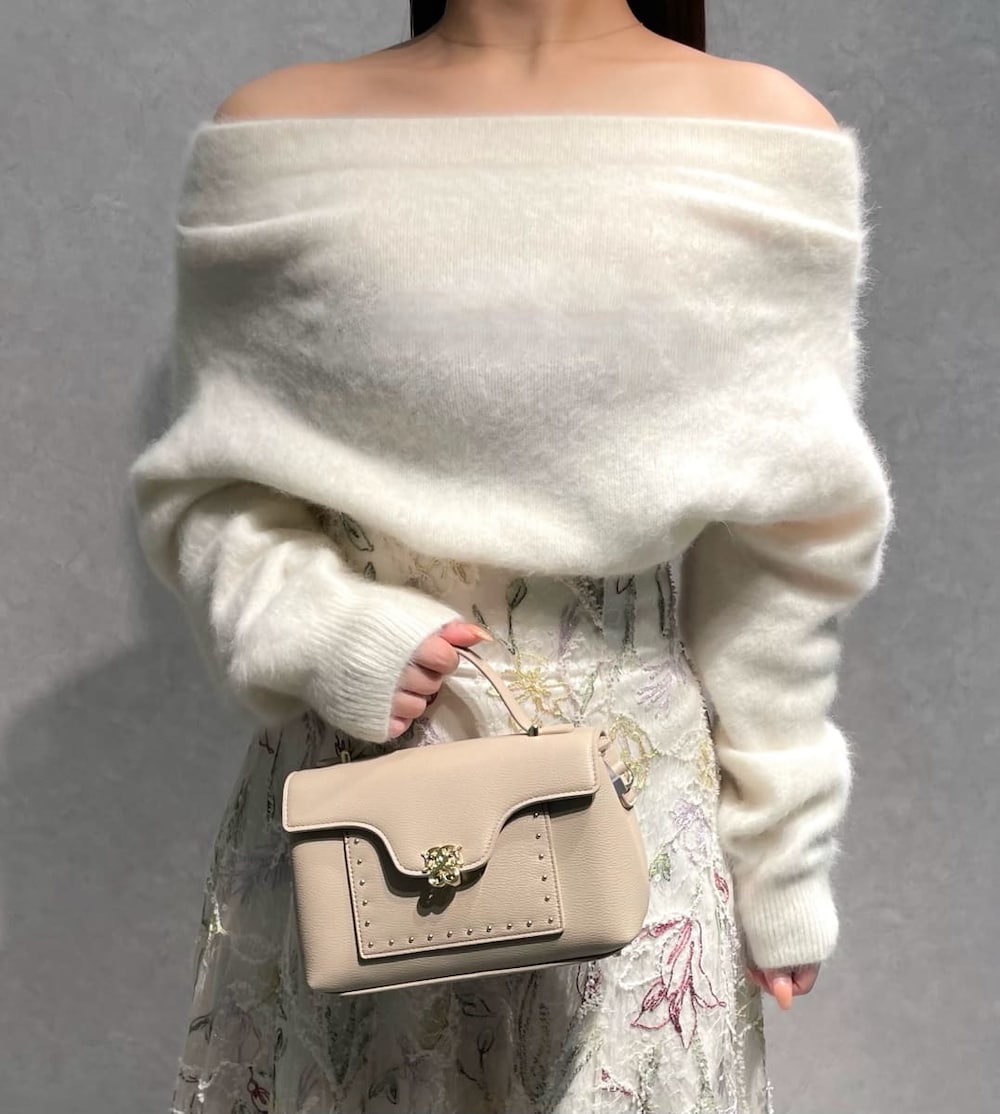 レッド系のブーツ、ベージュ系のショルダーバッグ、ホワイト系のニット/セーターを着用したレディースの秋コーディネートの5枚目の写真