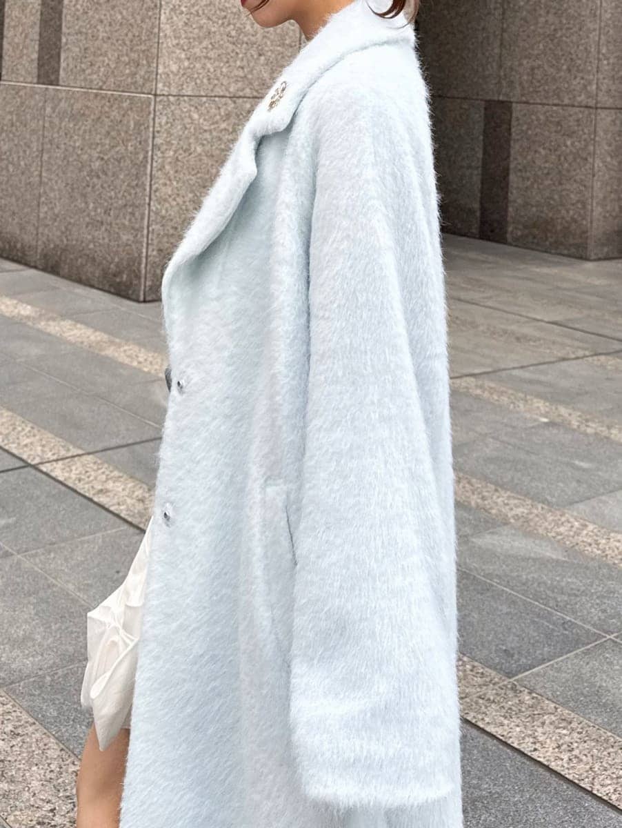 ブラック系のブーツ、ホワイト系のショルダーバッグ、ブルー系のチェスターコートを着用したレディースの冬コーディネートの2枚目の写真