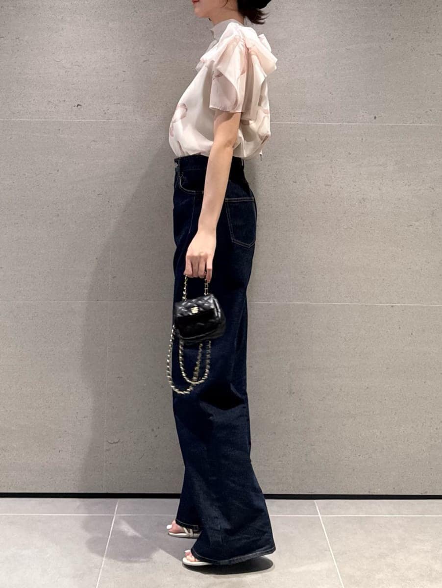 ブルー系のデニムパンツを着用したレディースの春コーディネートの2枚目の写真