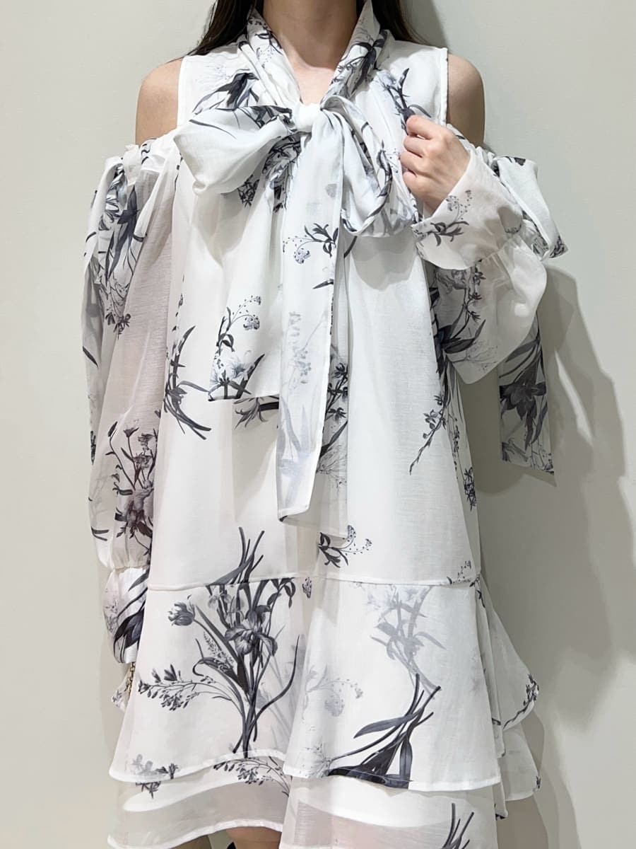 グレー系のブーツ、ホワイト系のワンピース、ホワイト系のショルダーバッグを着用したレディースの春コーディネートの2枚目の写真