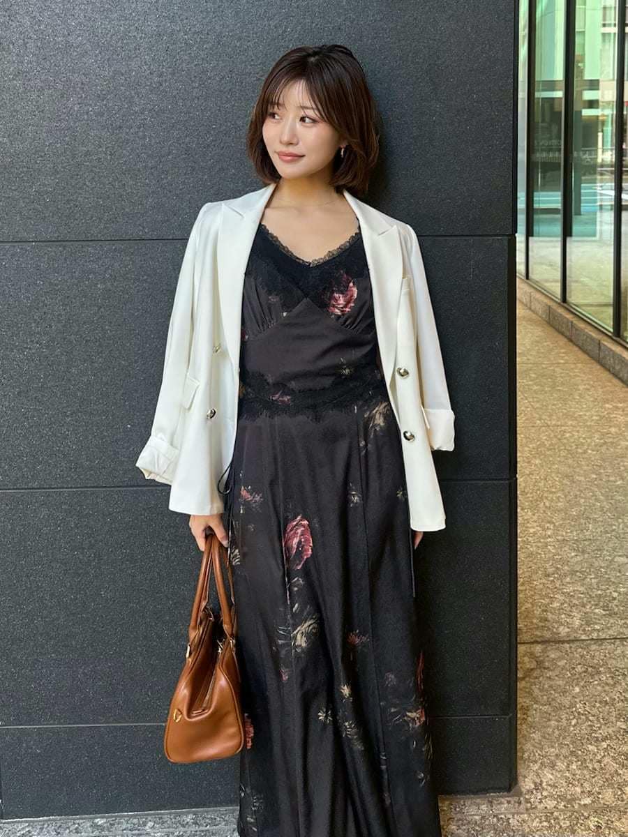 ブラック系のキャミソール、ホワイト系のテーラードジャケット、ブラック系のワンピースを着用したレディースの春コーディネートの6枚目の写真