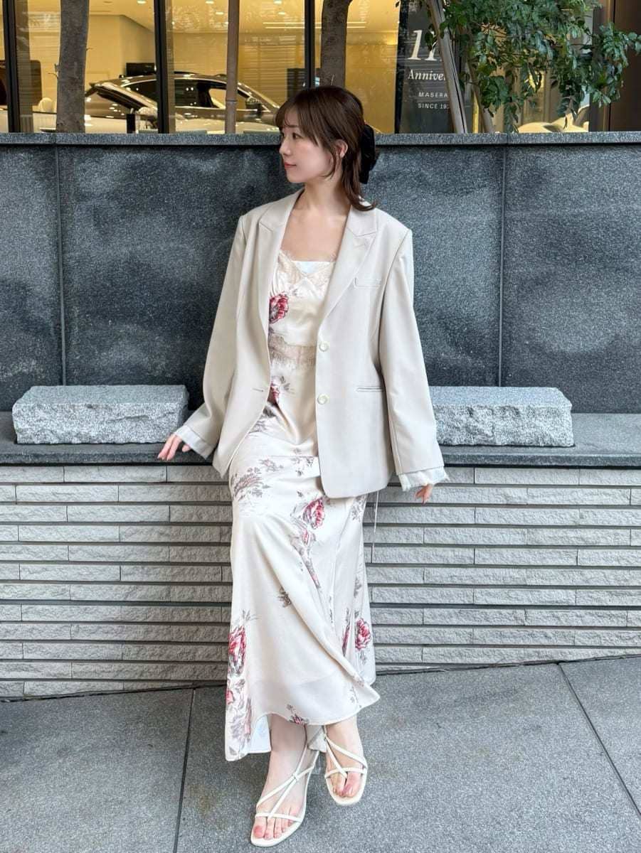 ホワイト系のキャミソール、ベージュ系のテーラードジャケット、ホワイト系のワンピースを着用したレディースの冬コーディネートの5枚目の写真