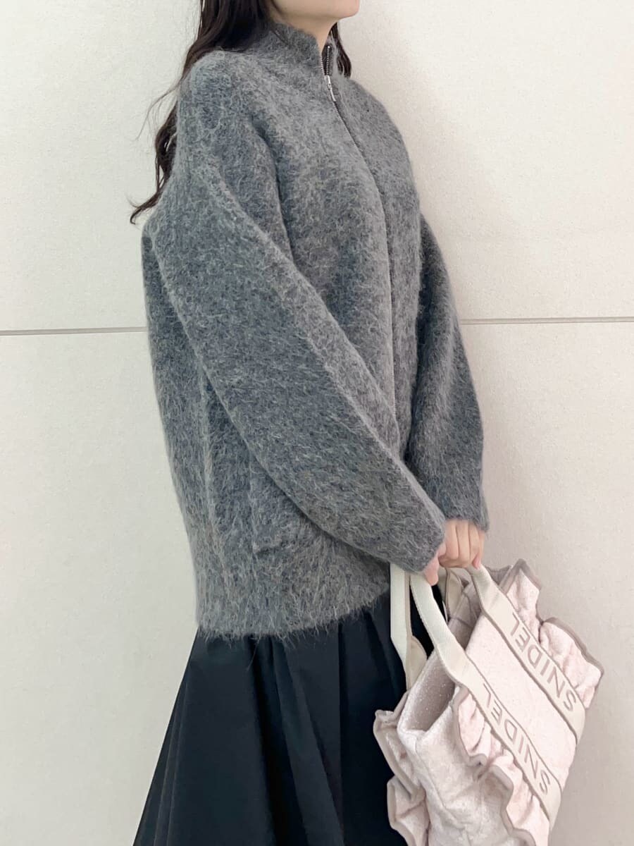 グレー系のブルゾン、ブラック系のスカート、ピンク系のハンドバッグを着用したレディースの秋コーディネートの6枚目の写真