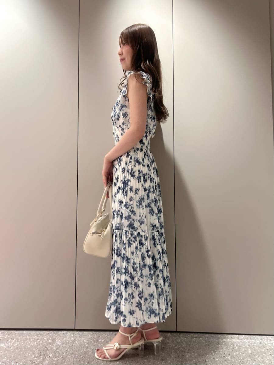 ブルー系のワンピース、ホワイト系のボストンバッグ、ベージュ系のショルダーバッグを着用したレディースの春コーディネートの2枚目の写真