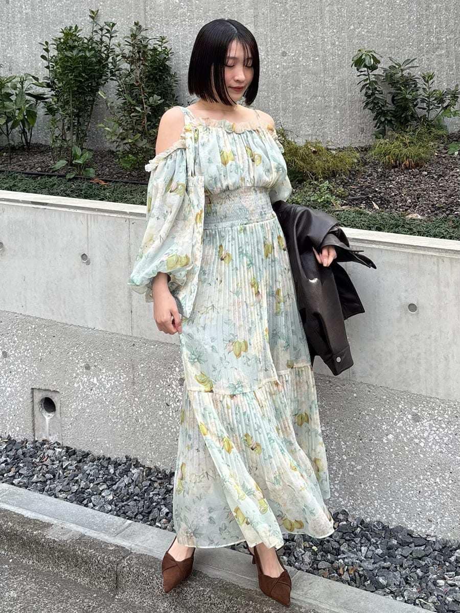 ブラウン系のブルゾン、グリーン系のワンピース、ブラウン系のパンプスを着用したレディースの冬コーディネートの6枚目の写真