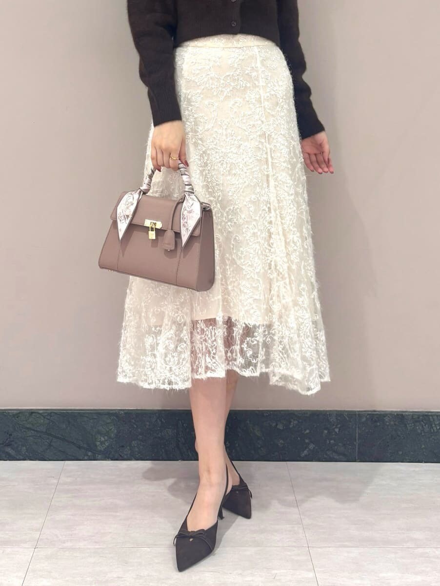 ブラウン系のカーディガン/ボレロ、ホワイト系のスカート、ピンク系のハンドバッグを着用したレディースの秋コーディネートの5枚目の写真
