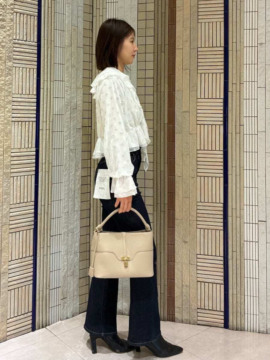 ブラック系のブーツ、ブルー系のその他パンツ、ブルー系のチェスターコートを着用したレディースの冬コーディネートの3枚目の写真