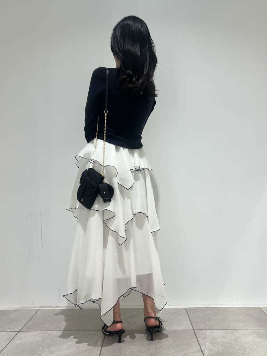 ブルー系のワンピース、ブラック系のパンプス、ブラック系のショルダーバッグを着用したレディースの冬コーディネートの3枚目の写真