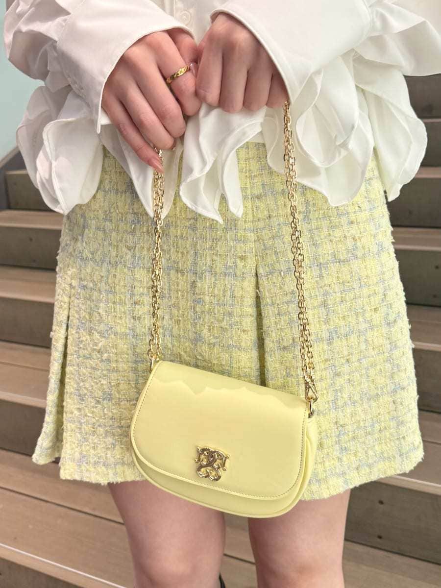 イエロー系のスカート、ホワイト系のシャツ/ブラウス、イエロー系のショルダーバッグを着用したレディースの冬コーディネートの8枚目の写真