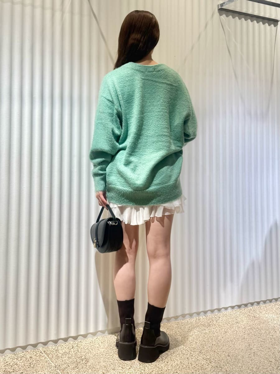 グリーン系のカーディガン/ボレロ、ホワイト系のその他パンツ、ブラック系のハンドバッグを着用したレディースの秋コーディネートの2枚目の写真