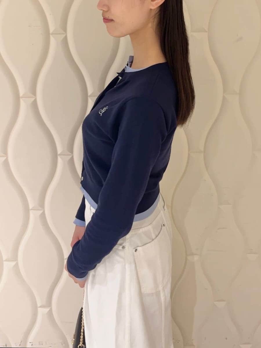 ブルー系のカーディガン/ボレロ、ブラック系のパンプス、ブラック系のショルダーバッグを着用したレディースの冬コーディネートの6枚目の写真