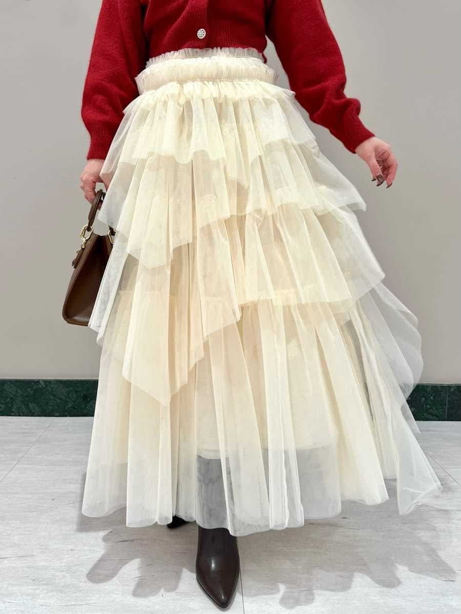 ブラウン系のブーツ、レッド系のカーディガン/ボレロ、ブラウン系のハンドバッグを着用したレディースの冬コーディネートの5枚目の写真