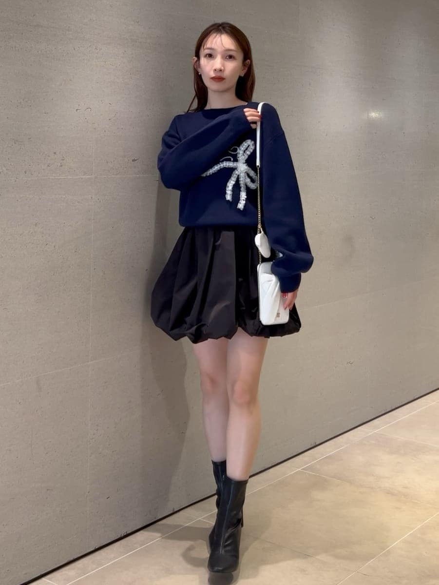 ブラック系のその他パンツ、ブルー系のニット/セーター、ホワイト系のショルダーバッグを着用したレディースの冬コーディネートの3枚目の写真