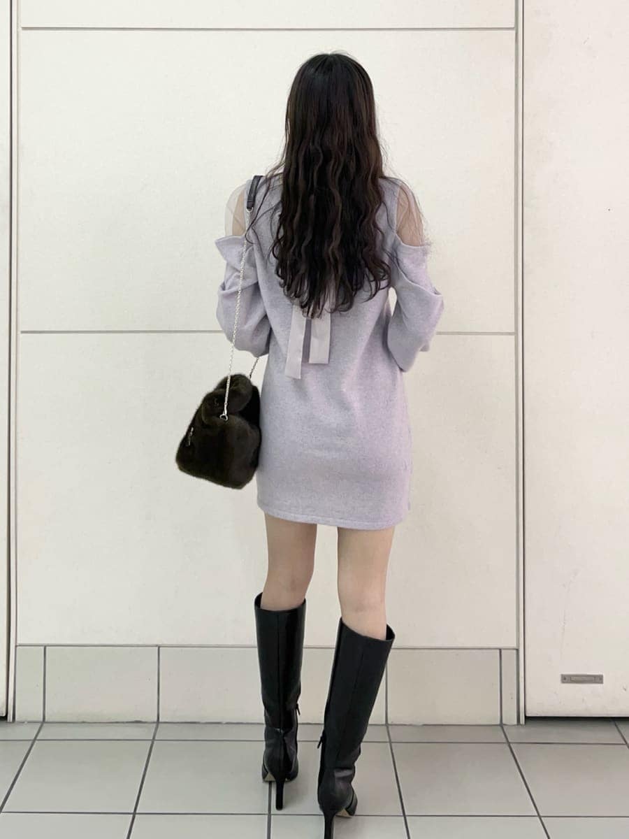 ブラック系のブーツ、パープル系のワンピース、ブラウン系のハンドバッグを着用したレディースの冬コーディネートの4枚目の写真