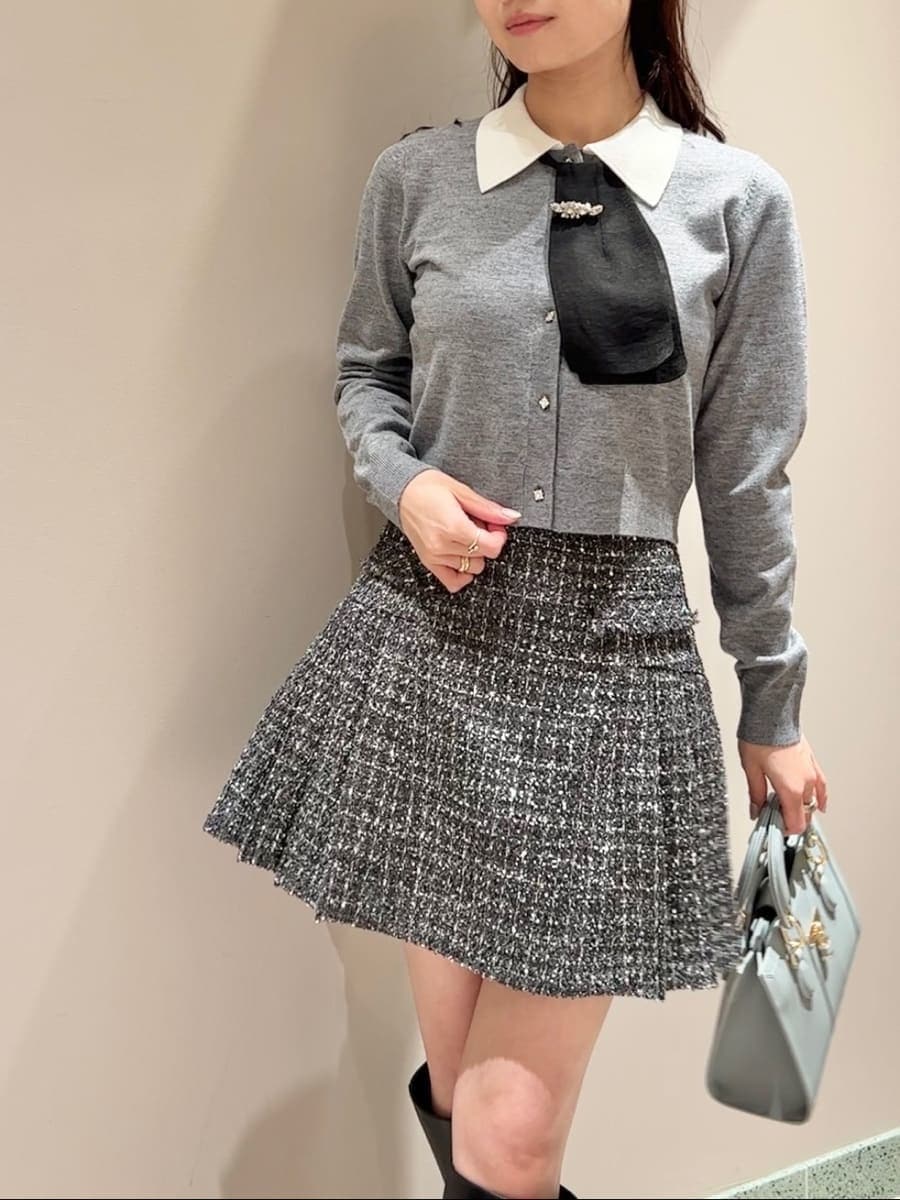 ブラック系のブーツ、グレー系のスカート、ブルー系のハンドバッグを着用したレディースの冬コーディネートの3枚目の写真