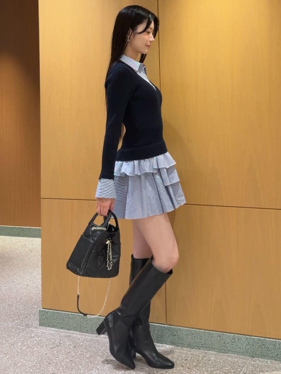 ブルー系のワンピース、ブラック系のブーツ、ブラック系のショルダーバッグを着用したレディースの秋コーディネートの2枚目の写真