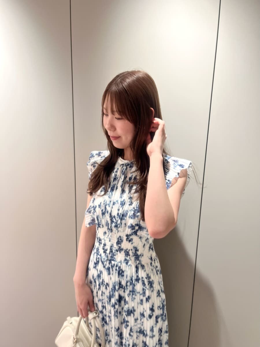ブルー系のワンピース、ホワイト系のボストンバッグ、ベージュ系のショルダーバッグを着用したレディースの春コーディネートの5枚目の写真