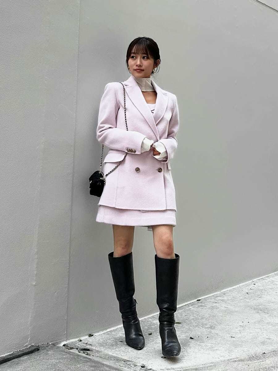 ピンク系のワンピース、ピンク系のテーラードジャケット、ブラック系のニット/セーターを着用したレディースの秋コーディネートの2枚目の写真