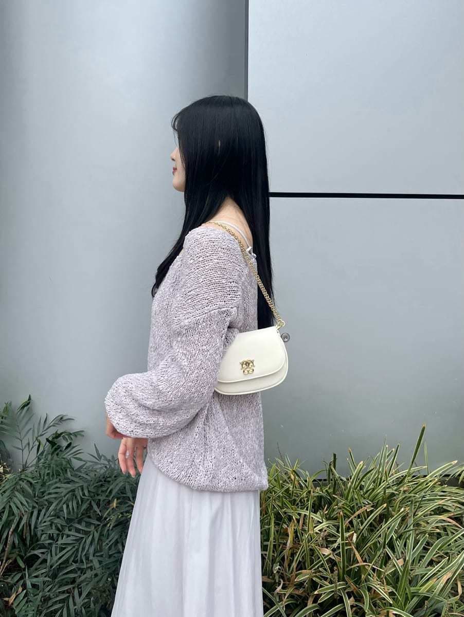 ブラック系のブーツ、パープル系のワンピース、ホワイト系のショルダーバッグを着用したレディースの冬コーディネートの5枚目の写真