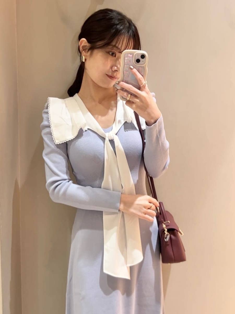 ブラウン系のブーツ、ブラウン系のショルダーバッグ、ブルー系のワンピースを着用したレディースの冬コーディネートの7枚目の写真