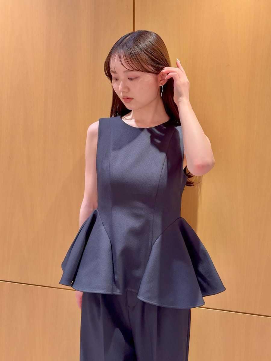 ブルー系のワンピース、ブラック系のパンプス、ホワイト系のハンドバッグを着用したレディースの春コーディネートの4枚目の写真