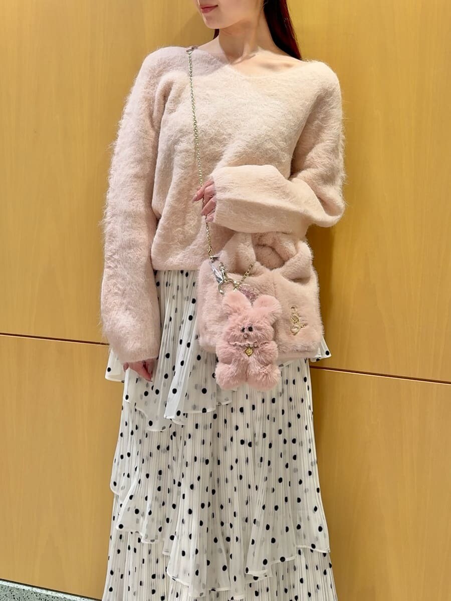 ピンク系のニット/セーター、その他のスカート、ピンク系のハンドバッグを着用したレディースの秋コーディネートの6枚目の写真