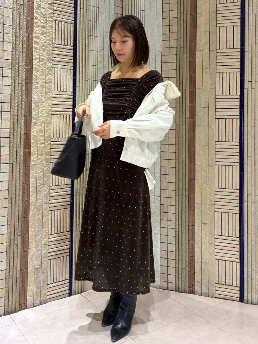 ブラック系のブーツ、ホワイト系のブルゾン、その他のワンピースを着用したレディースの冬コーディネートの2枚目の写真