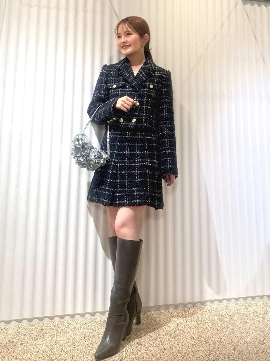 グレー系のブーツ、ブルー系のテーラードジャケット、ブルー系のスカートを着用したレディースの春コーディネートの2枚目の写真