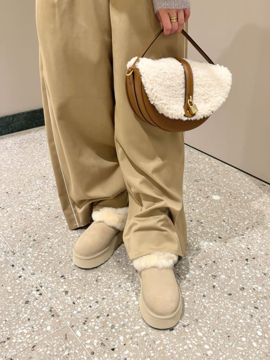 グレー系のカーディガン/ボレロ、ベージュ系のその他パンツ、イエロー系のハンドバッグを着用したレディースの秋コーディネートの6枚目の写真